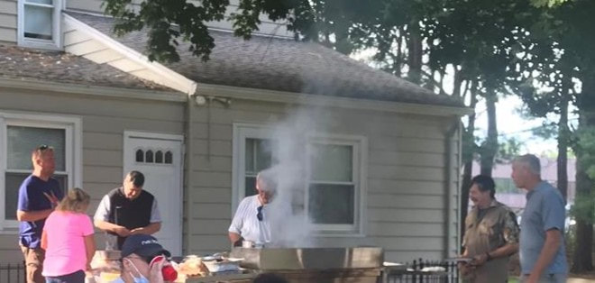 People preparing food on the grill at the annual picnic at PVURC.