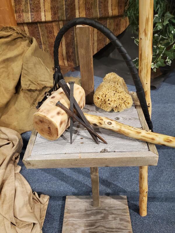 Close-up view of the hammer and nails in a Good Friday diorama display.