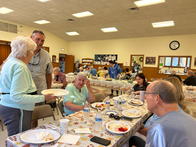 People enjoying good food and fellowship at the PVURC church picnic.