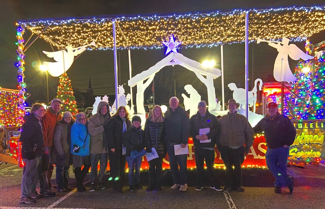 Church members posing in front of the PVURC float before the Christmas parade.